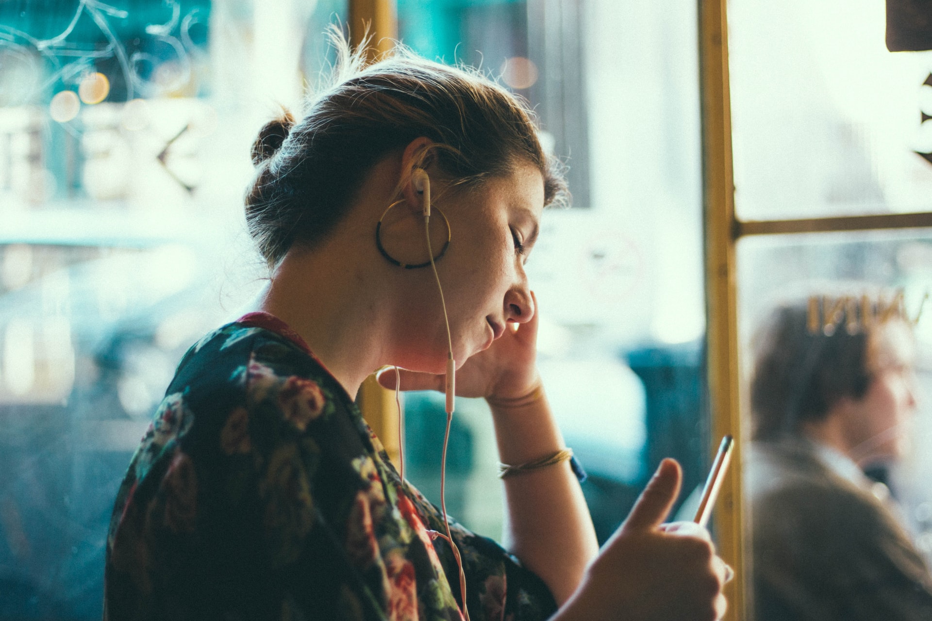 An image of a woman listening to music in her earbuds 